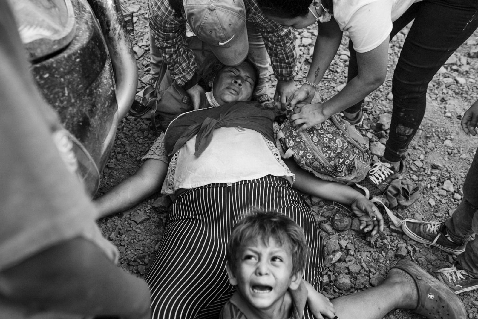 Jessica Rivas, 30, lays down as she faints during clashes between police officers and a ten thousand people caravan directed to the north in Vado Hondo, Guatemala, on January 18, 2021. Her 4-years-old son Isaac cries as his mother doesn't wake up.
The photographer has followed Jessica, Isaac, and her older son Juan David, 12, through Guatemala, and regularly visited them in Tapachula, Mexico, where they spent one month in a charity shelter. 
From Tapachula, the family moved north to Piedras Negras, a town bordering the United States in the Mexican Coahuila state. Fearing expulsion, Rivas decided to send Juan David alone across the border, a telephone number written in a paper in his pocket, to reunite with a family member in the United States. She is currently living with Isaac in Piedras Negras, determined to cross the border one day.
The photographer documented Jessica's story during the past year. Rivas agreed that her story would be published, hoping that American authorities, knowing her struggles, would grant her family asylum.