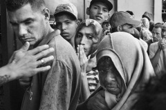 People wait in line for a free meal at Casa de Paso Divina Providencia, a charity organization run by the Catholic Diocese of Cucuta, in Villa del Rosario, Colombia, on June 25, 2018. Since March 2020, as a lockdown to prevent contagion was imposed in Colombia, community refectories have been closed, making it more difficult for charity organizations to reach the migrants and offer them food in the streets. According to the diocese's figures, the distribution of daily meals dropped from 13 thousand by 2019 to 1500 in 2021 and 2022.
In 2020, the photographer continued to monitor the increasingly harsh living conditions of Venezuelan refugees and migrants coping with the pandemic via video interviews, made possible by the cooperation of workers at Casa de Paso.
Each photo of this body of work received the prior or posterior consent of the people depicted. People wait in line for a free meal at Casa de Paso Divina Providencia, a charity organization run by the Catholic Diocese of Cucuta, in Villa del Rosario, Colombia, on June 25, 2018. Since March 2020, as a lockdown to prevent contagion was imposed in Colombia, community refectories have been closed, making it more difficult for charity organizations to reach the migrants and offer them food in the streets. According to the diocese's figures, the distribution of daily meals dropped from 13 thousand by 2019 to 1500 in 2021 and 2022.
In 2020, the photographer continued to monitor the increasingly harsh living conditions of Venezuelan refugees and migrants coping with the pandemic via video interviews, made possible by the cooperation of workers at Casa de Paso.
Each photo of this body of work received the prior or posterior consent of the people depicted.