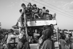 People crowd onto a truck at the entrance of an illegal dirt road connecting Colombia and Venezuela in Paraguachón, La Guajira, Colombia, on July 6, 2018.
The 2219 km-long frontier between the two countries only counts on seven official immigration checkpoints (UNHCR). Venezuelan refugees and migrants are exposed to abuse, trafficking, and recruitment in no man's borderlands, where illegal groups control people's movement and smuggling.
Since 2018, when the migration crisis worsened, dozens of thousands of Venezuelan families set up tent cities on the outskirts of indigenous towns. By documenting the constant movement of people at the border and the intolerable living conditions in the informal camps, the photographer felt two collapsing worlds were colliding in a region already suffering from extreme poverty.
At this crossing point, cars and trucks used to stop to let people get in and out, an opportunity for Wayuu children to sell water and snacks, and for the photographer to briefly exchange words with the people on the move, and share his intentions for photographing. People crowd onto a truck at the entrance of an illegal dirt road connecting Colombia and Venezuela in Paraguachón, La Guajira, Colombia, on July 6, 2018.
The 2219 km-long frontier between the two countries only counts on seven official immigration checkpoints (UNHCR). Venezuelan refugees and migrants are exposed to abuse, trafficking, and recruitment in no man's borderlands, where illegal groups control people's movement and smuggling.
Since 2018, when the migration crisis worsened, dozens of thousands of Venezuelan families set up tent cities on the outskirts of indigenous towns. By documenting the constant movement of people at the border and the intolerable living conditions in the informal camps, the photographer felt two collapsing worlds were colliding in a region already suffering from extreme poverty.
At this crossing point, cars and trucks used to stop to let people get in and out, an opportunity for Wayuu children to sell water and snacks, and for the photographer to briefly exchange words with the people on the move, and share his intentions for photographing.