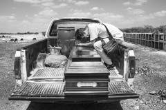 Luis Arevalo, who migrated from Venezuela to Colombia in search of job opportunities, sits in the back of a pickup truck, mourning his sister Luisana in Riohacha, Colombia, on August 17, 2018.
She died asphyxiated in a car, and her family could not afford the cost of repatriating the body to Venezuela. Luisana’s mother could travel to Colombia to assist with the funeral in a private cemetery, thanks to the support of a local NGO.
In recent years, so many dead bodies in the streets at night ended up in the crowded city's cemeteries. Without registering, people often bury the dead in uncultivated fields out of the city line. Of many with no name, there will be no trace left. It will be impossible for their families in Venezuela to know what happened to them and find or repatriate the remains.
Luisana's relatives agreed that the photographer would document the funeral to shed light on their struggles. "I used to believe in the revolution, but now the world must know what Maduro is doing to the people of Venezuela," -Luisana's mother said. Luis Arevalo, who migrated from Venezuela to Colombia in search of job opportunities, sits in the back of a pickup truck, mourning his sister Luisana in Riohacha, Colombia, on August 17, 2018.
She died asphyxiated in a car, and her family could not afford the cost of repatriating the body to Venezuela. Luisana’s mother could travel to Colombia to assist with the funeral in a private cemetery, thanks to the support of a local NGO.
In recent years, so many dead bodies in the streets at night ended up in the crowded city's cemeteries. Without registering, people often bury the dead in uncultivated fields out of the city line. Of many with no name, there will be no trace left. It will be impossible for their families in Venezuela to know what happened to them and find or repatriate the remains.
Luisana's relatives agreed that the photographer would document the funeral to shed light on their struggles. "I used to believe in the revolution, but now the world must know what Maduro is doing to the people of Venezuela," -Luisana's mother said.