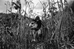 A man holds his daughter while hiding from the police in Vado Hondo, Guatemala, on January 18, 2021.
After Guatemalan security forces tried to break up a 10,000-person -strong caravan to stop their northward journey, people dispersed into the woods and, in smaller groups, continued to walk.
The photographer has documented the migrant caravan from San Pedro Sula to Vado Hondo for three days until attempts to dialogue between people and Guatemalan authorities failed, ending in a violent confrontation.