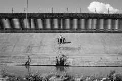 A woman crosses the Rio Grande with two children in Ciudad Juarez, Mexico, on March 27, 2021. Asylum seekers often turn themselves into the American authorities to initiate a formal request for political asylum. However, between 2020 and 2021, thousands of families were expelled and returned to Mexico. The authorities denied their asylum claims with arguments based on Title 42, a U.S. statute that allows the expulsion of asylum seekers from a country where a virus such as Covid-19 is present. According to U.S. Customs and Border Protection data, 2021 was a record for children and teenagers crossing the border without their parents. By March, 8500 children who had crossed the border alone were currently housed in Department of Health and Human Services shelters, while others 3,500 more were waiting at Border Patrol stations for beds in those shelters to open up. June was the fourth consecutive month that apprehensions and detentions surpassed 170,000.