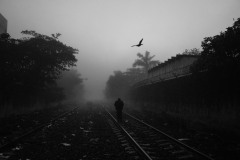 A railway officer walks along tracks in Coatzacoalcos, Mexico, on February 17, 2021. Migrants sometimes try to jump aboard a cargo train known as The Beast to head north. There, the risk of kidnapping and assaults makes the path dangerous.