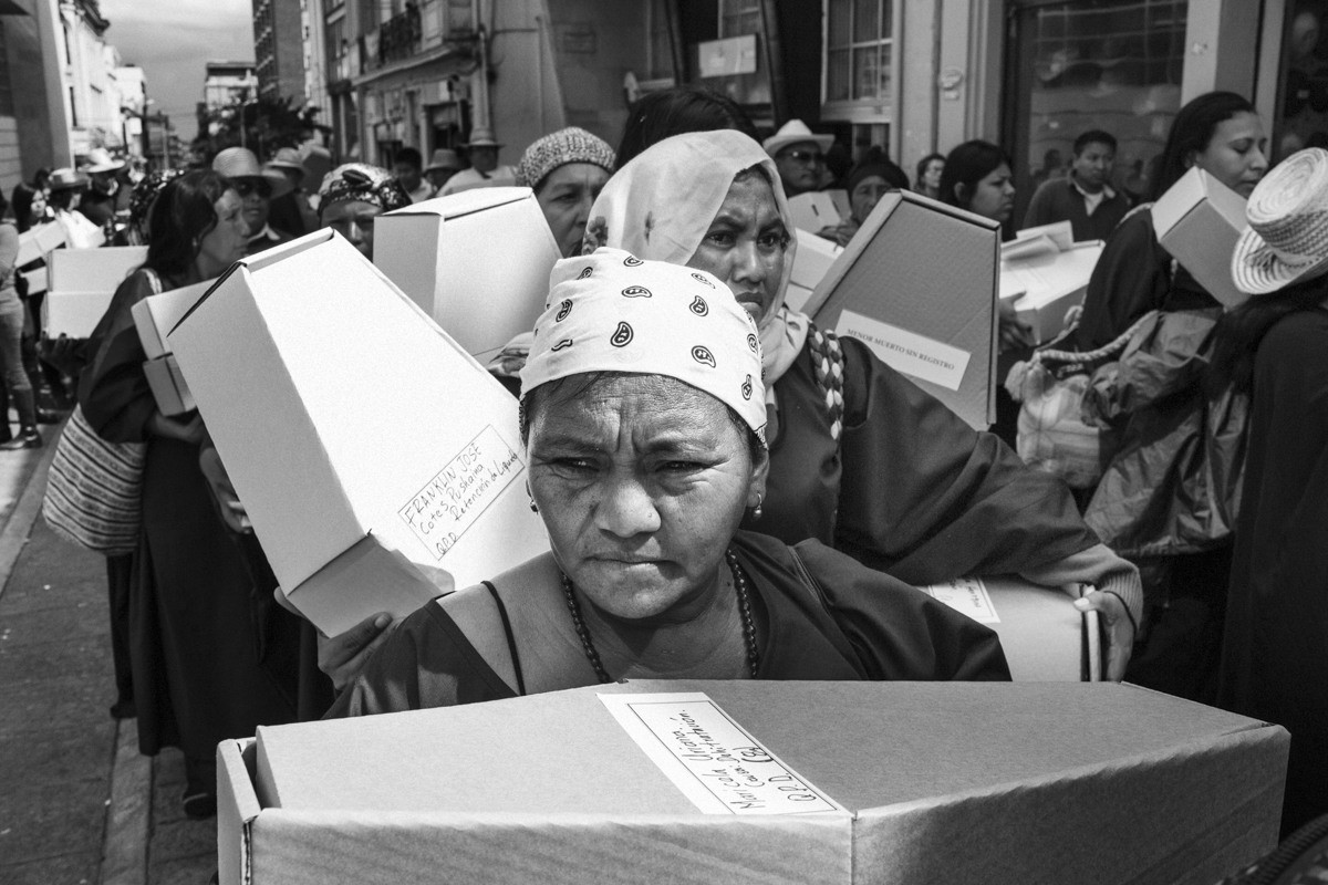 Protestors carry 500 child-size coffins made of paper In Bolivar square; in Bogotá in 2016; to protest the death of Wayuu children.