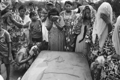 Members of the community stand at the grave of a 2-year-old who they said died of a fever. Wayuu consider death as important or more important than life. During funerals, Wayuu women cry and cover their faces with veils or towels. They say their tears accompany the soul of the dead to “Jepirra” or the afterworld.