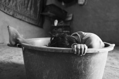 Jaider David Apinayu; 8; lies in a bucket. His family says he is malnourished and unable to stand or speak. He spent most of his time in a hammock or a large bucket that his family used to transport him outside of the house. Jaider died in March; 2020.