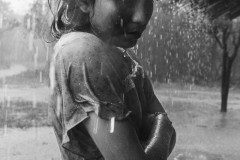 Rain falls on a girl after a long drought.