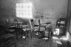 Sunlight shines through a window inside an abandoned school. Built by the government, the school was never active as no scholar program was put in place.