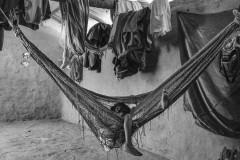 Jaider David Apinayu; 8; lies in a hammock. His family says he is malnourished and unable to stand or speak. He spent most of his time in a hammock or a large bucket that his family used to transport him outside of the house. Jaider died in March; 2020.