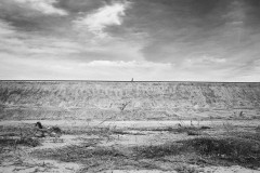 A man walks along the coal train railway.