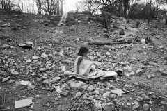 Mildred sits on a cardboard in the backyard of her family home, a few kilometers away from the Cerrejon coal mine. Daily explosions in the mine spread a vast quantity of coal dust in the air, which is affecting nearby communities. Moises, 2, brother of MIldred and Yeleinis, is suffering a permanent lung infection.
