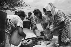 People fill tanks with water from a water truck brought by a Bogotá-based NGO that supplies water to more than 32 communities around the municipality of Manaure every day.