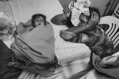 A woman sits besides her son at Manaure Hospital. Wayuu women often walk hours through the desert to reach the closest hospital, and when they arrive, they often find the doctors do not speak their language.