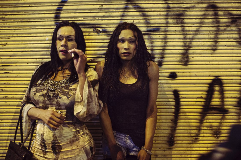 Carolina, 36 and Barbara, 32 are smoking a marijuana joint during a night of work in the barrio Santa Fe'.